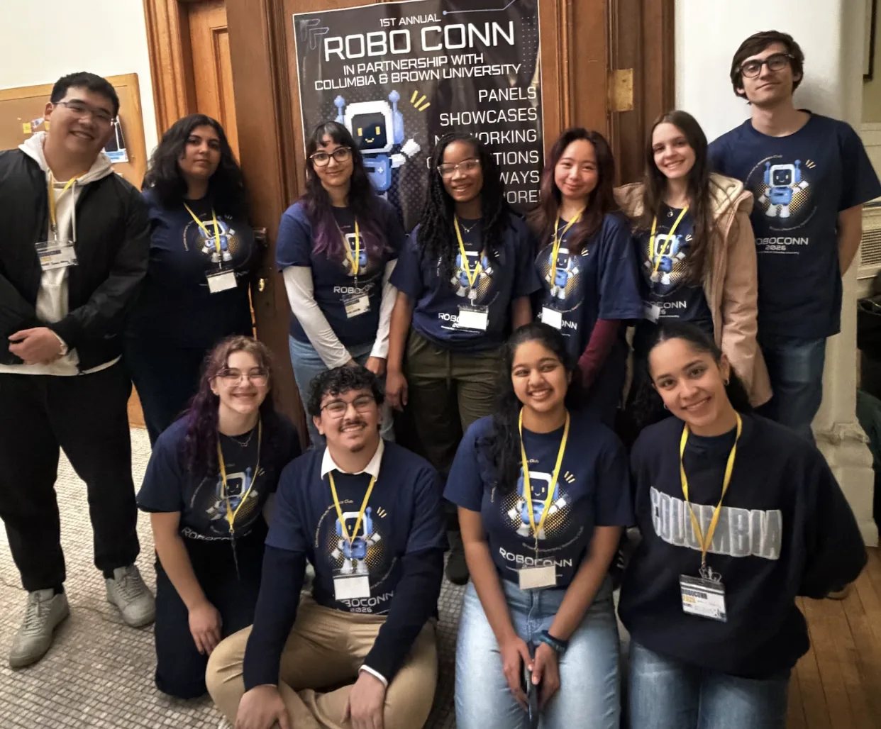RoboCONN organizers and volunteers posing together in front of the RoboCONN banner
