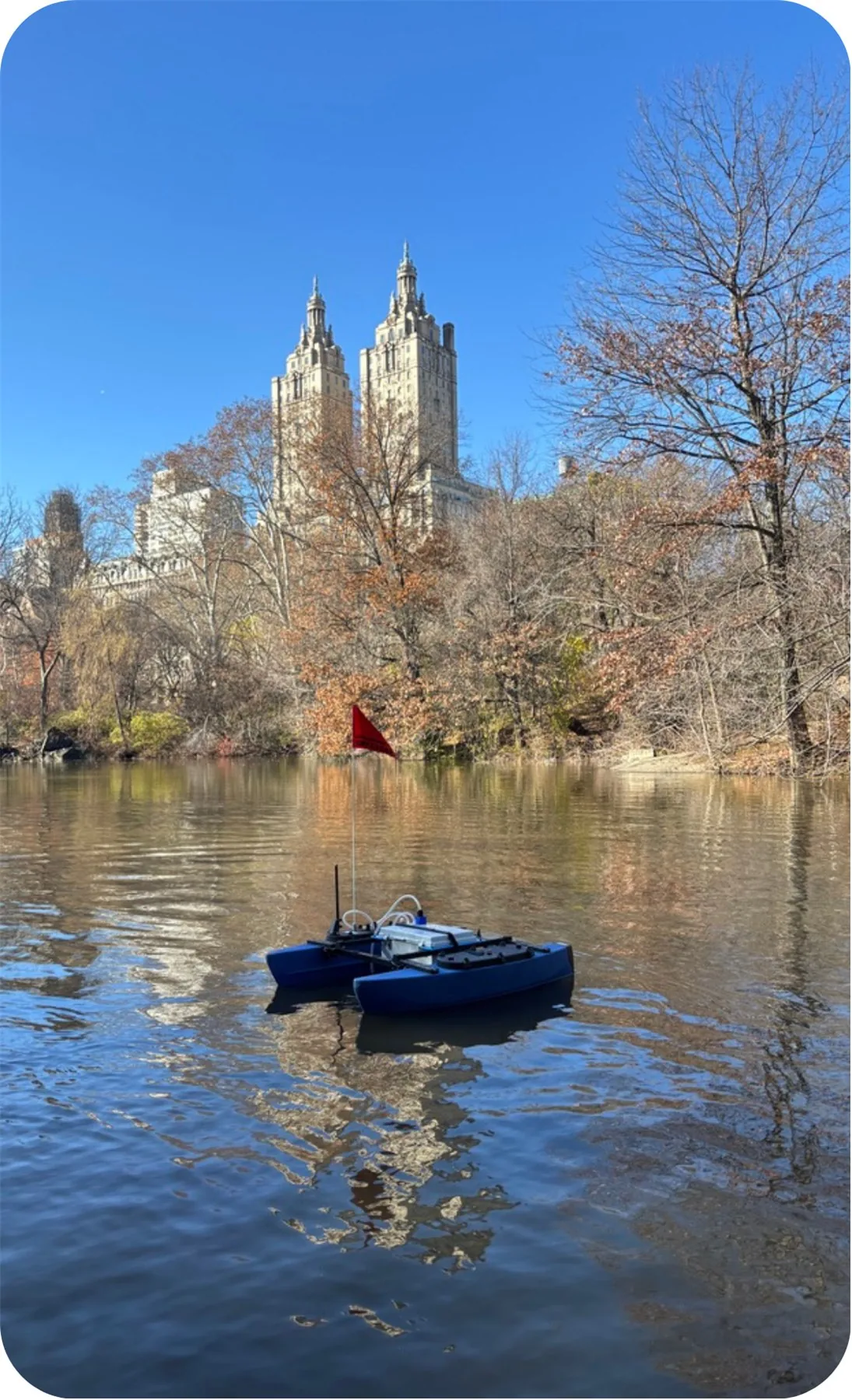 AQUAS vessel operating on a lake with New York buildings behind it