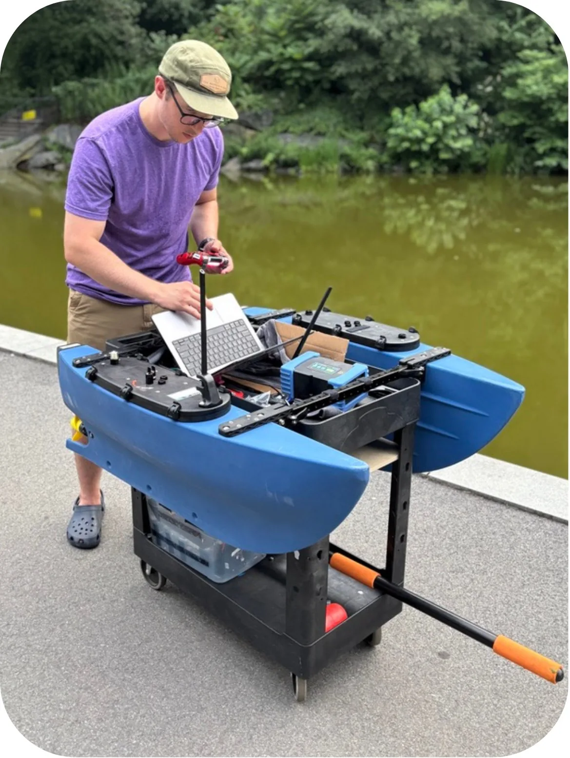 AQUAS team member preparing the vessel beside a pond