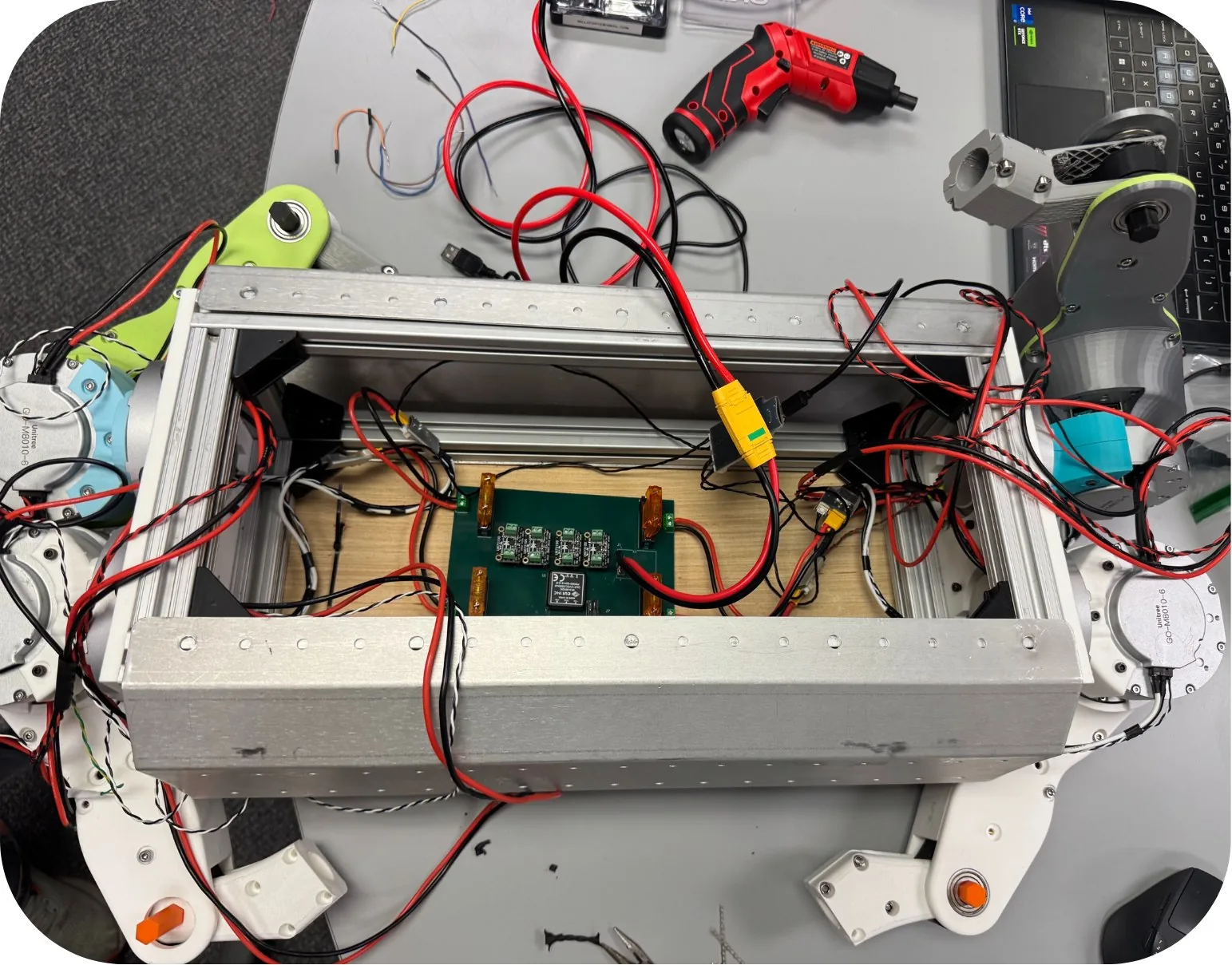 Open CCBR quadruped chassis showing motors, wiring, and control electronics
