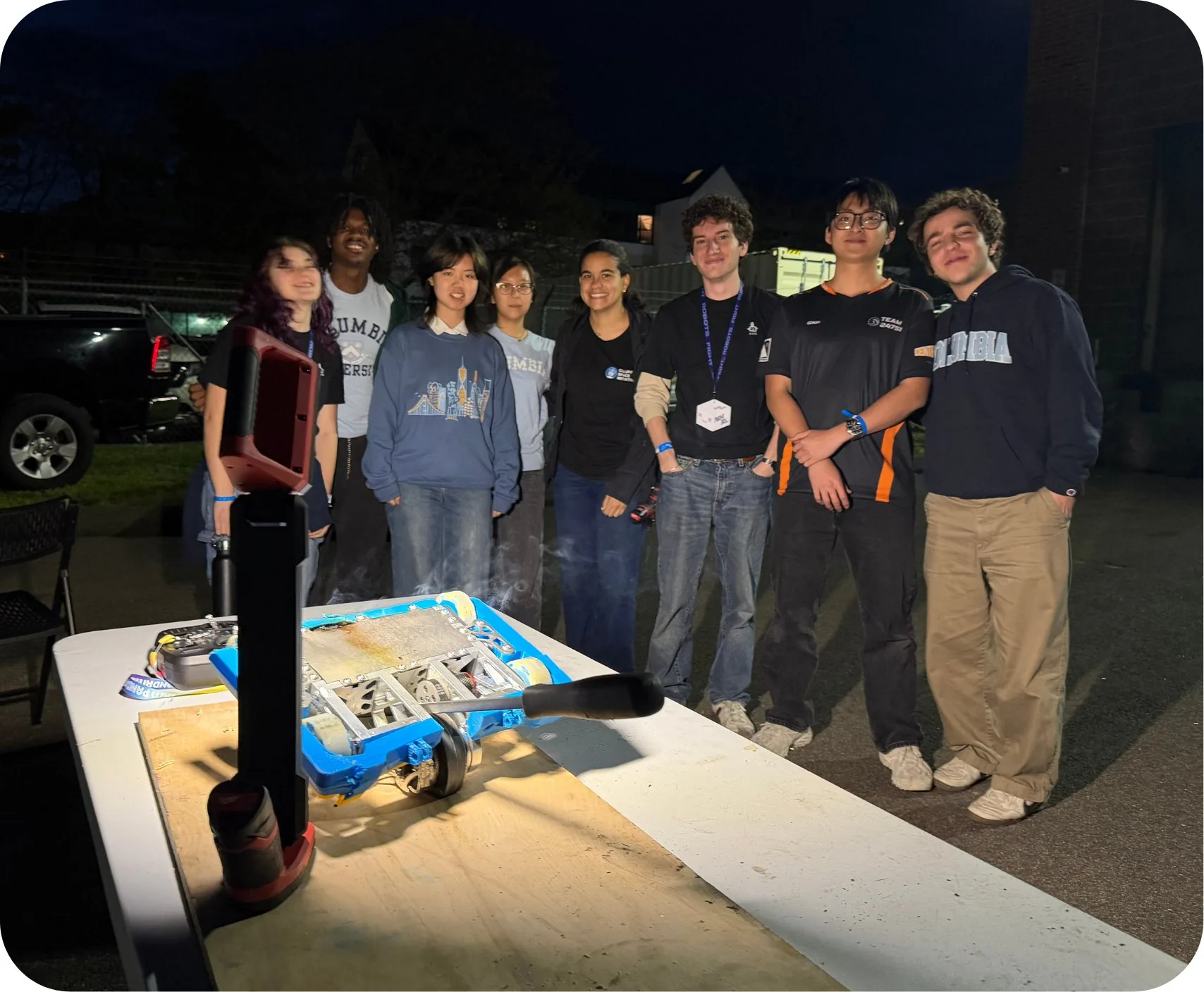 Combat Robotics team gathered with a robot after an event